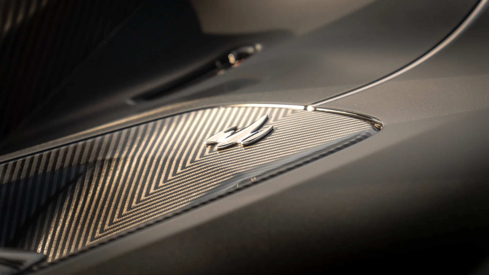 Carbon-fibre detail of a Koenigsegg Jesko under warm directional light